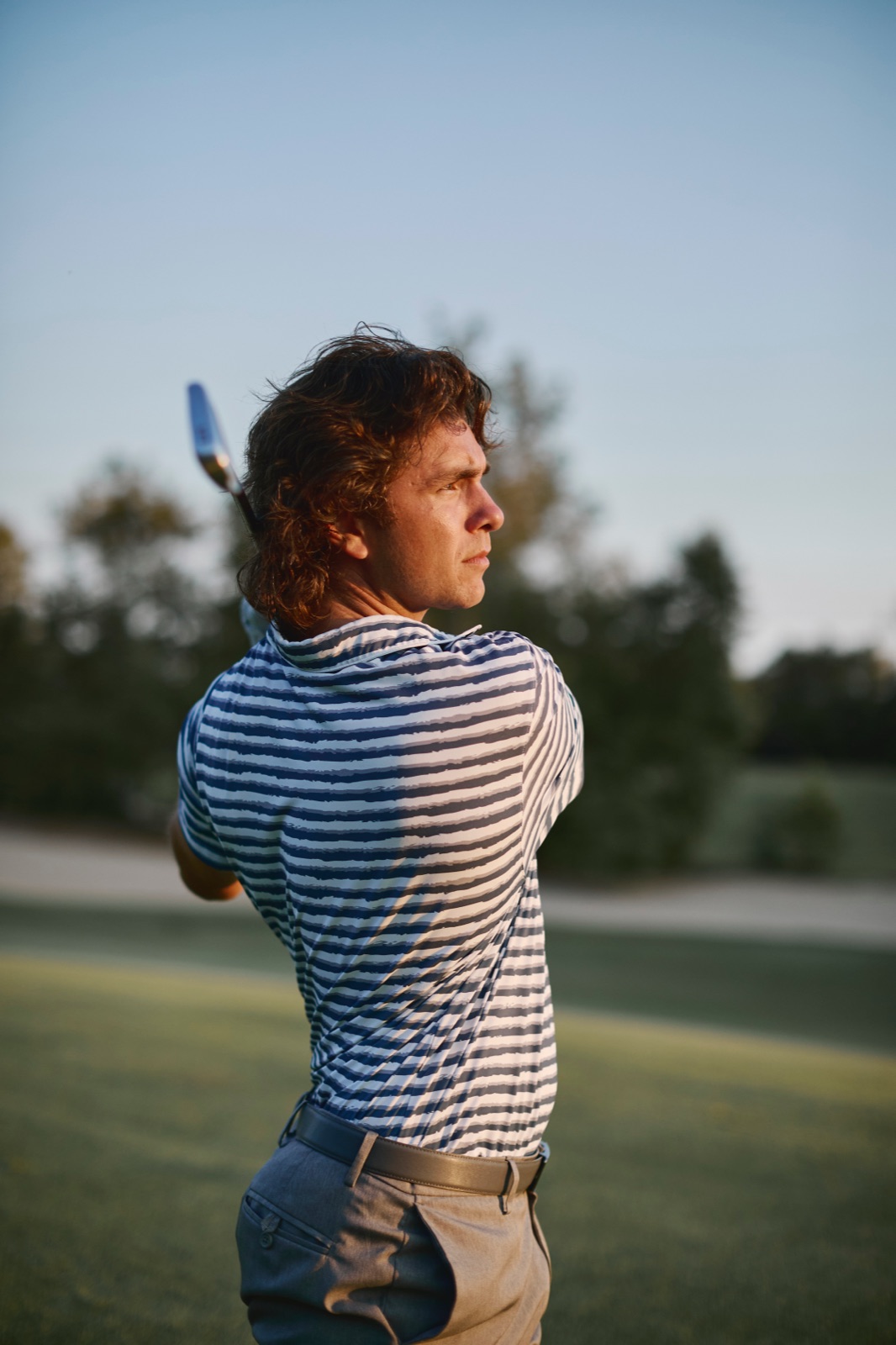 Ari watching his ball flight at golden hour